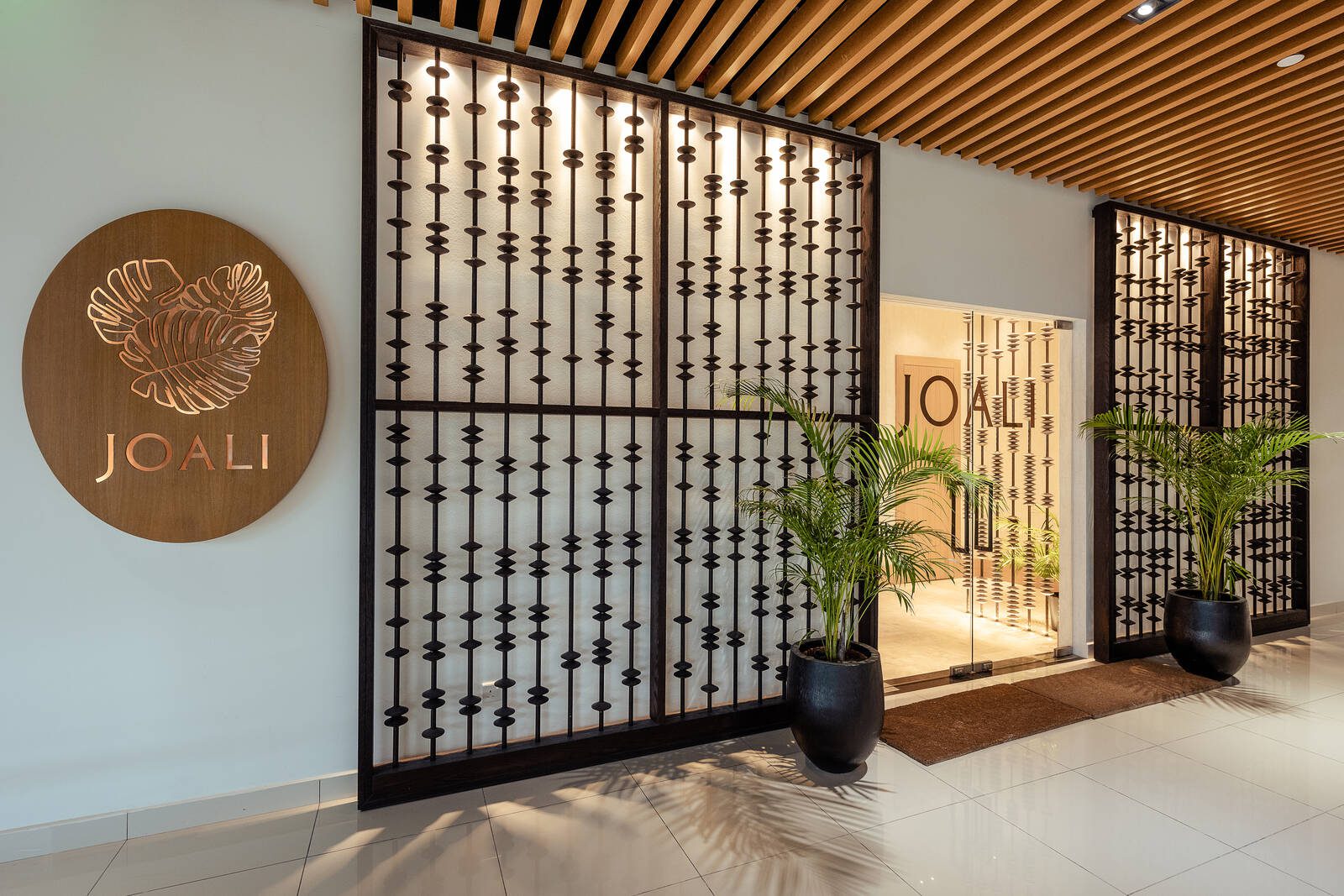 馬列機場 JOALI Lounge 入口,牆上圓形木牌寫著 JOALI